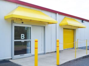 AA Self Storage office entrance with bright yellow awning and glass door at the Lynchburg VA facility