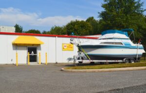 boat and trailer parked at AA Self Storage boat and RV storage area in Lynchburg VA with facility building in background