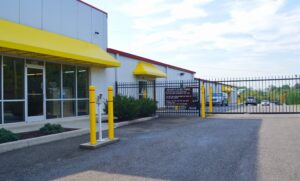 AA Self Storage office entrance with yellow awnings and secure gated entry at the Lynchburg VA facility on Young Place