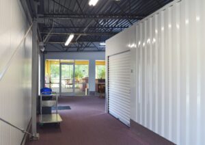 interior hallway at AA Self Storage in Lynchburg VA with hand truck, trash can, and roll-up storage