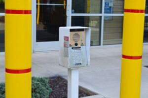 secure gate keypad access system at AA Self Storage in Lynchburg VA with controlled entry and yellow bollards