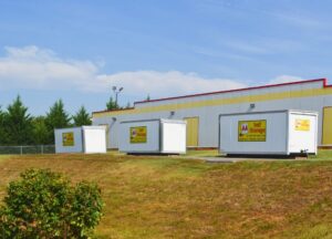 portable storage containers lined up outside AA Self Storage facility in Lynchburg VA with the main building in the background