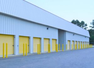long building of standard drive up self storage units with yellow doors in Oxford NC