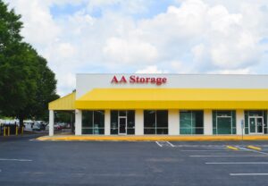 front entrance of the AA Self Storage building in Raleigh NC featuring a bright yellow awning and convenient parking