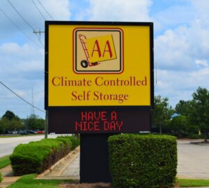 large yellow AA Self Storage sign advertising climate controlled units at the Raleigh NC facility with digital message board