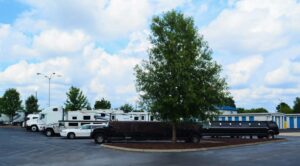 vehicle storage area at AA Self Storage in Raleigh NC showing covered vehicles and outdoor parking under blue sky